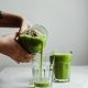 pouring green drink on glass