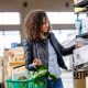 woman with grocery basket getting box