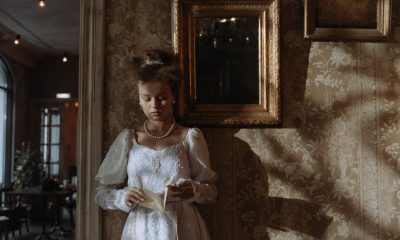 19th century woman standing against the wall