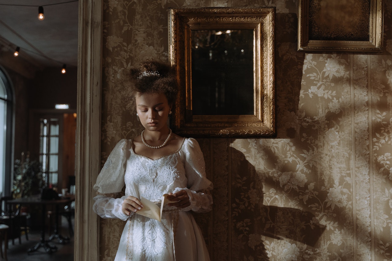 19th century woman standing against the wall