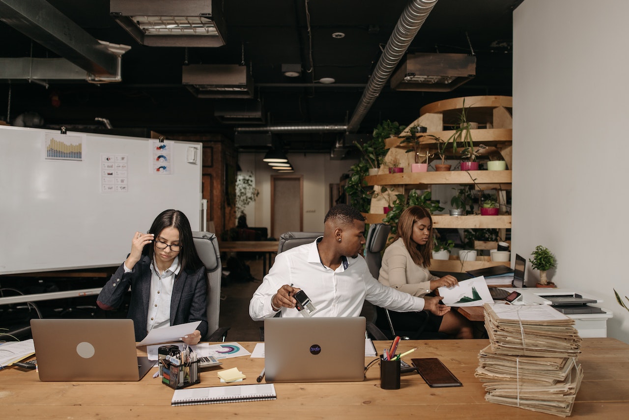 women and man working on desk