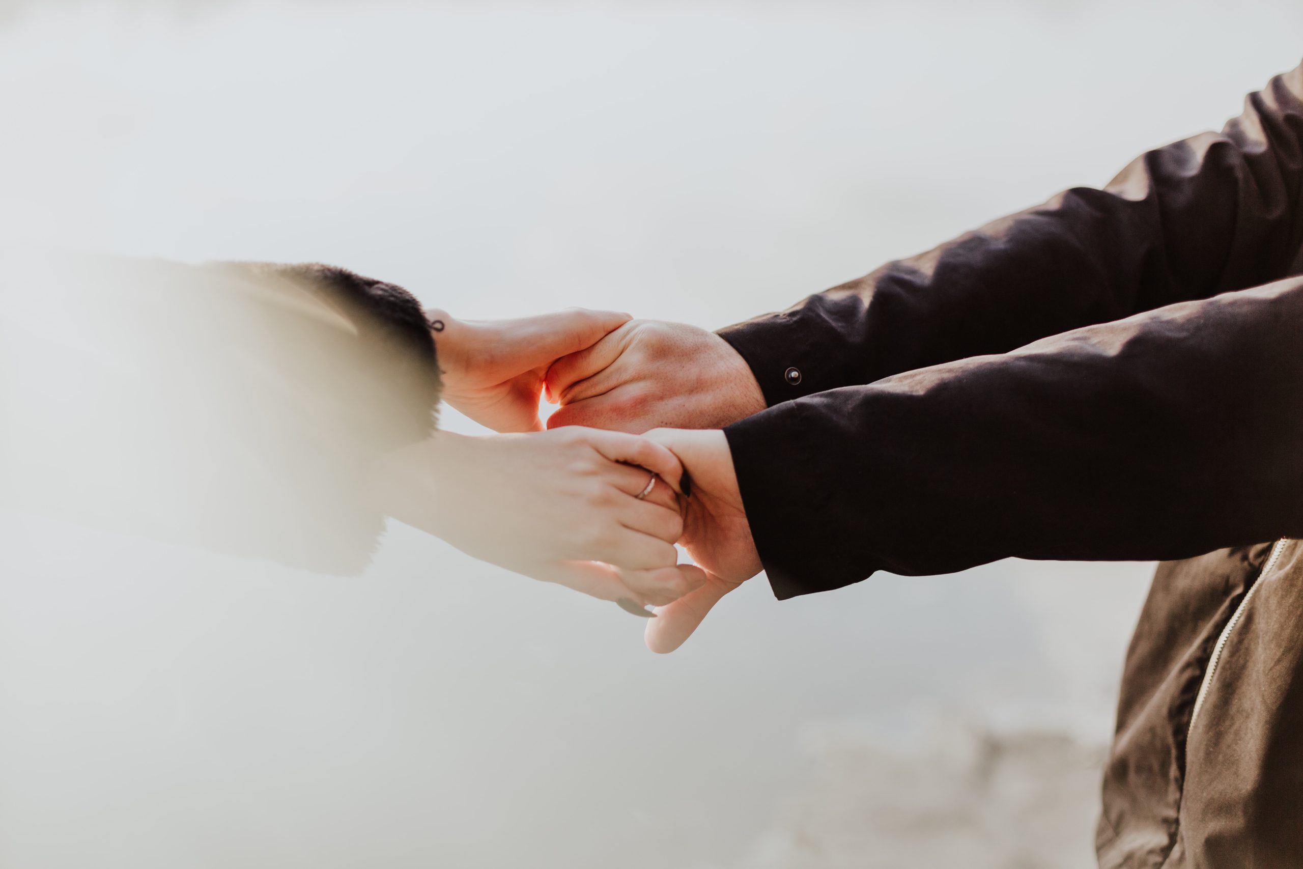 Two persons holding hands