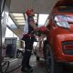 gasoline station employee fills up a vehicle