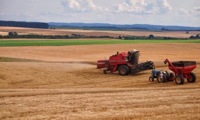 Farmers using Tractors on a Farm Field