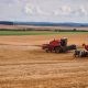 Farmers using Tractors on a Farm Field