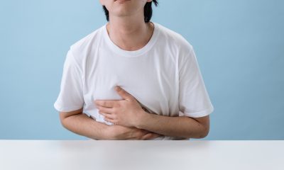 Man in White Shirt Suffering from a Stomach Pain