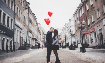 couple kissing in the middle of a street