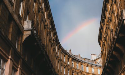 Old city district against blue sky with rainbow