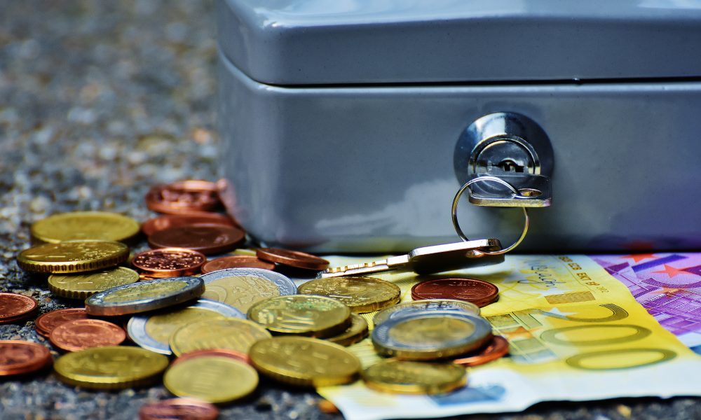 Banknotes and Coins Beside Gray Safety Box