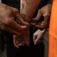 officer putting handcuff on prisoner