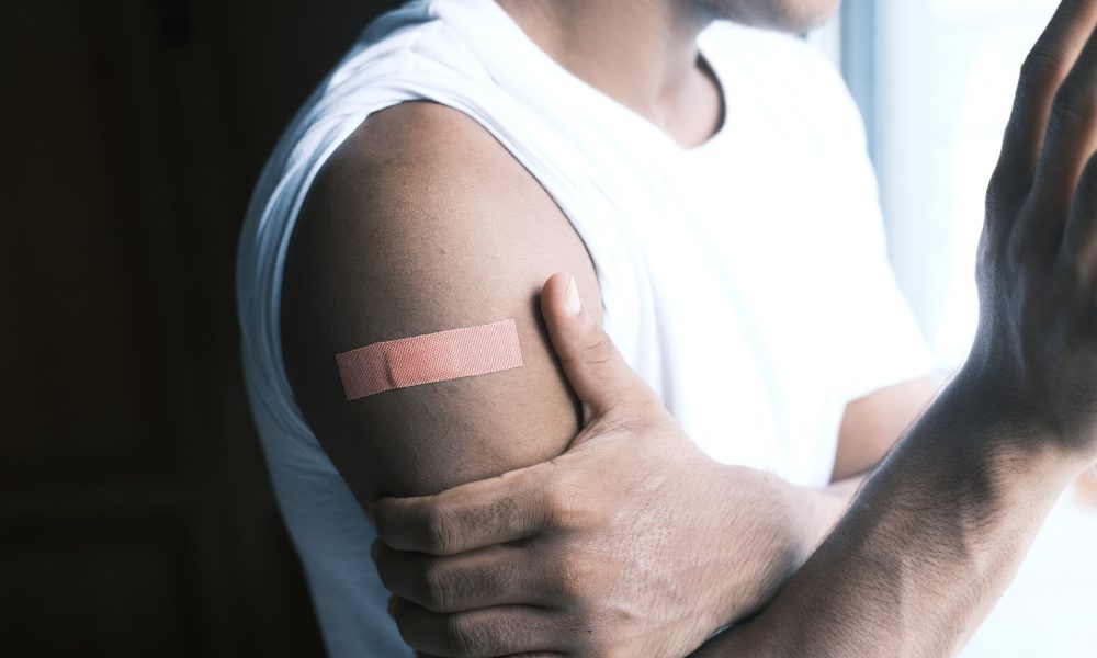 man's arm with bandaid