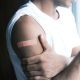 man's arm with bandaid