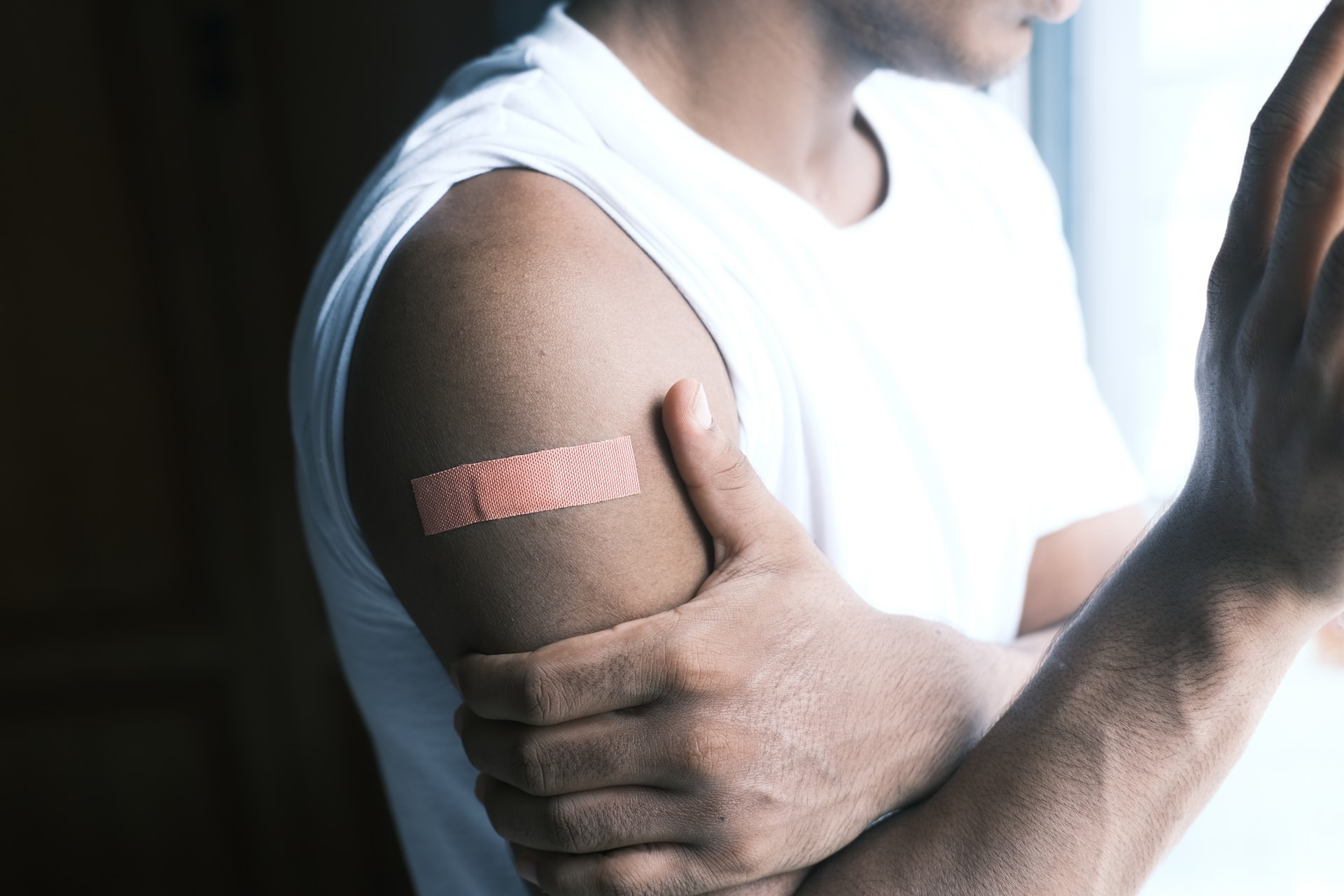 man's arm with bandaid