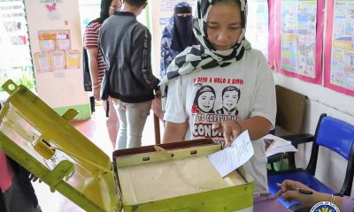 person drawing her ballot
