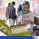 person drawing her ballot