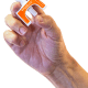 A hand holding a Kloxxado intranasal spray device. With the tip inserted into the nostril of someone who has suspected overdose, a dose of naloxone is administered by using one's thumb to push the plunger up toward the index and middle fingers.