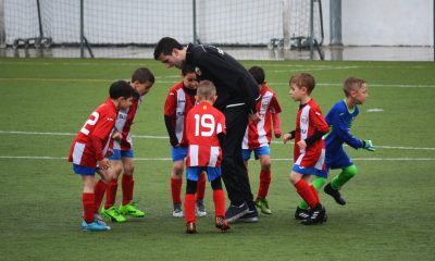 kids playing football with coach