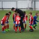 kids playing football with coach