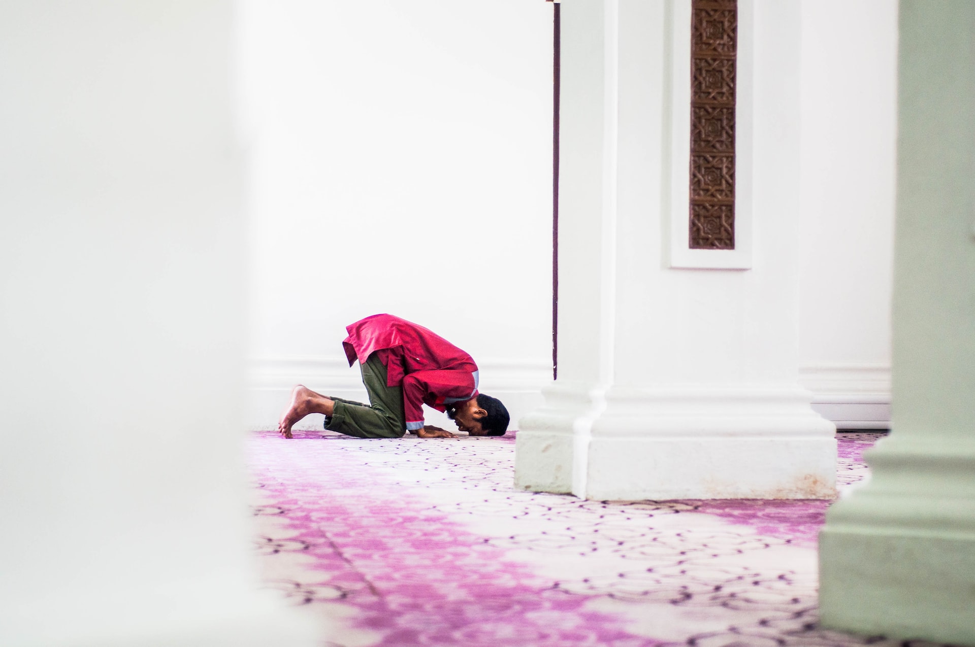 man praying in mosque