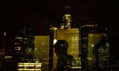 silhouette of man with skyscraper background