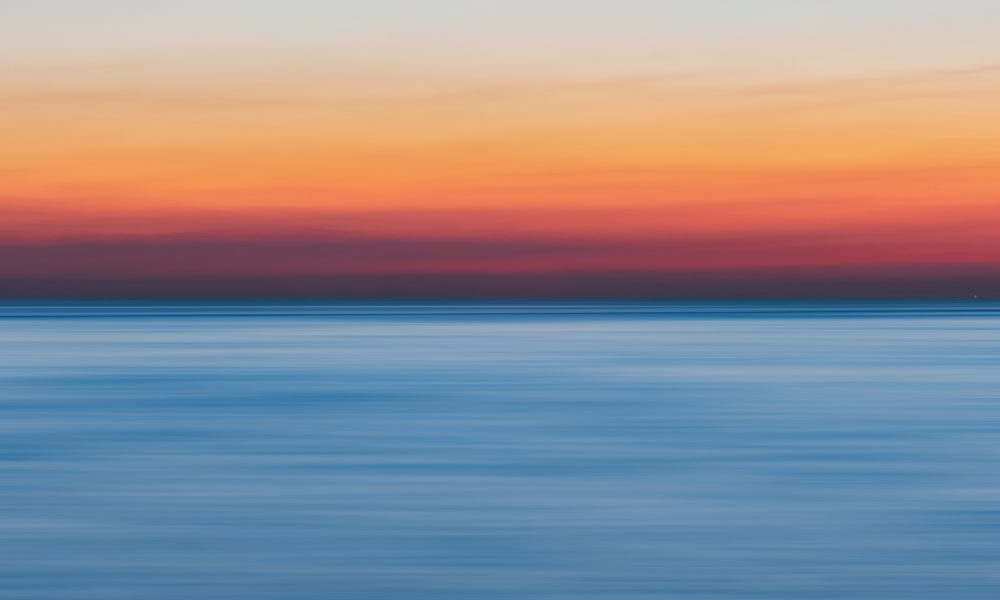 Calm Body Of Water During Golden Hour