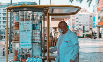 Man Standing Near a Food Cart