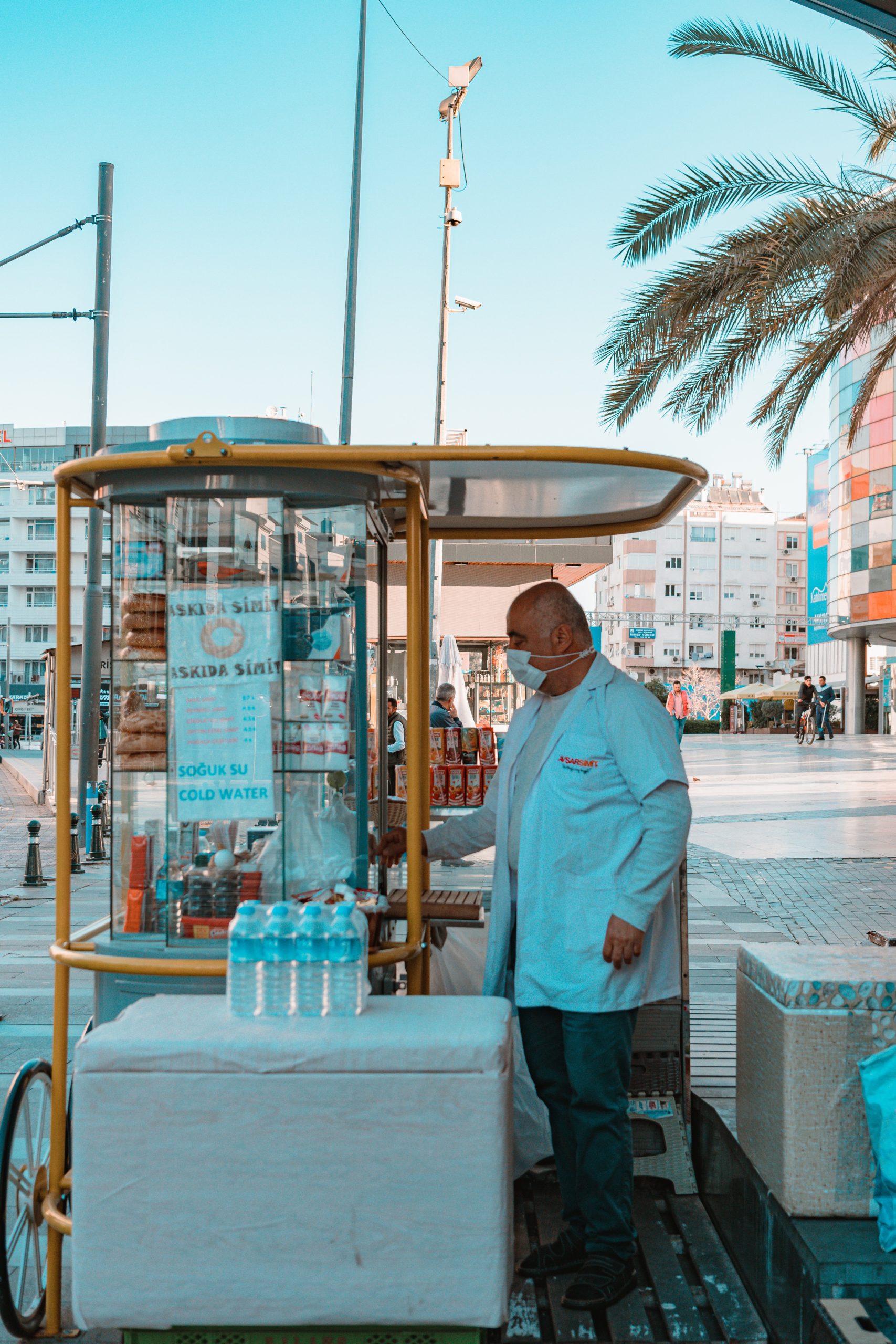 Man Standing Near a Food Cart