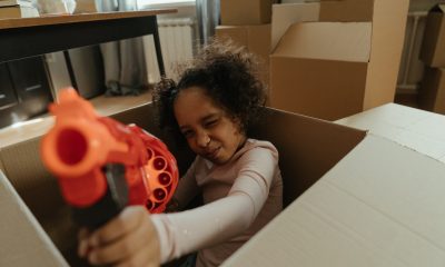 Girl in White Long Sleeve Shirt Holding Red and Black Cordless Hand Drill