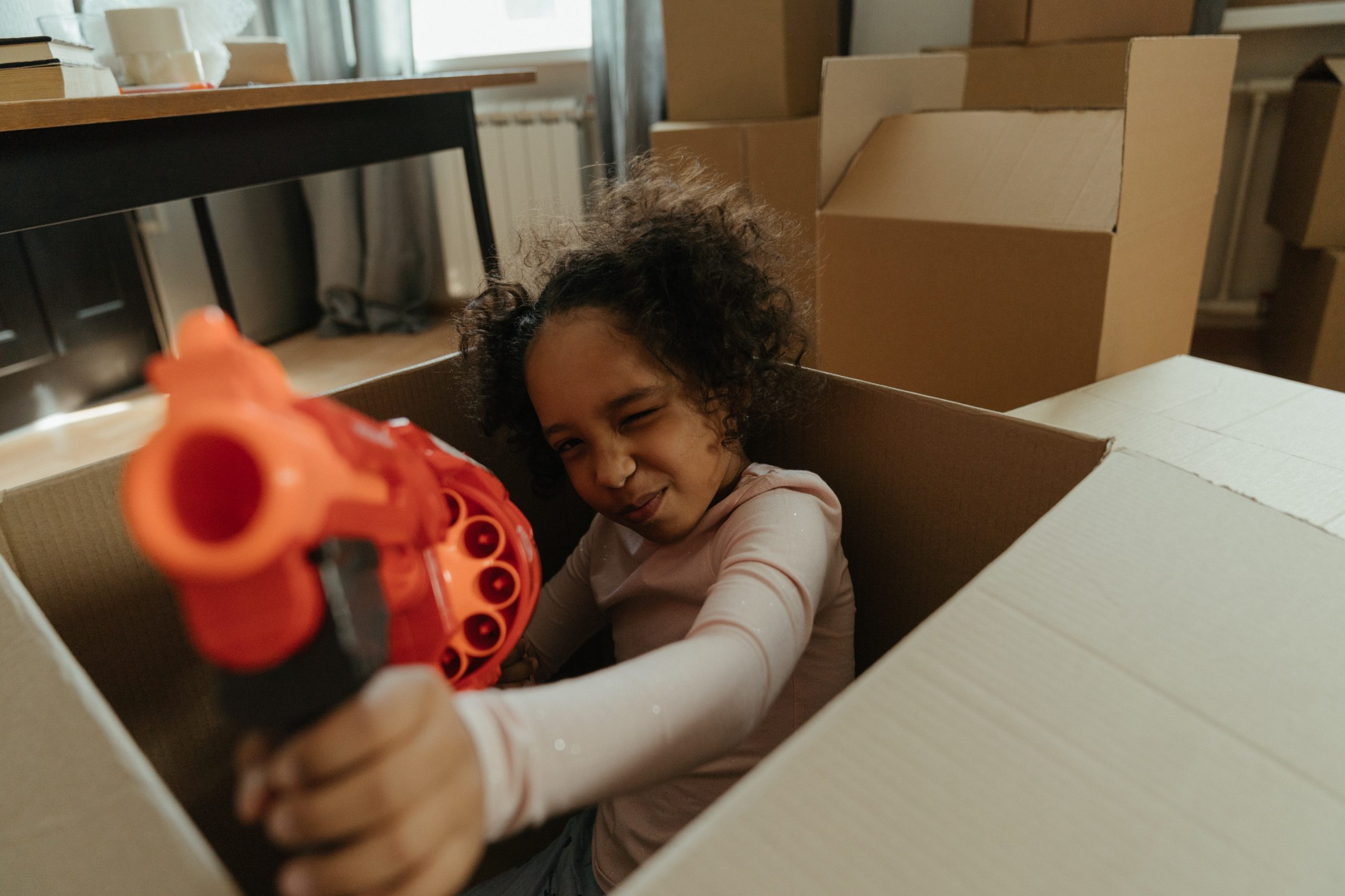 Girl in White Long Sleeve Shirt Holding Red and Black Cordless Hand Drill