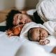 father and son sleeping on bed