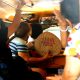 woman fanning with abaniko inside a jeepney
