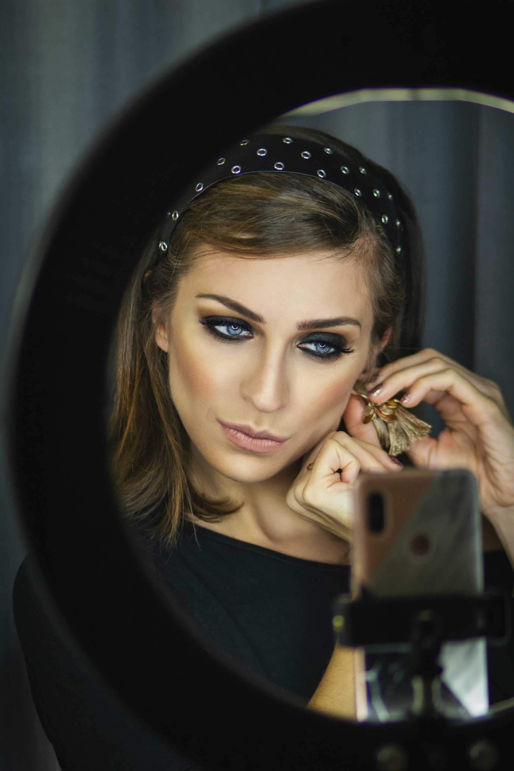 woman in front of ring light and phone camera