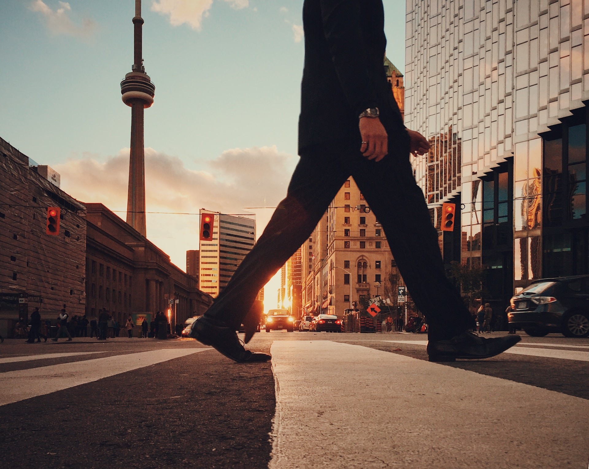 legs crossing street with canada buildings