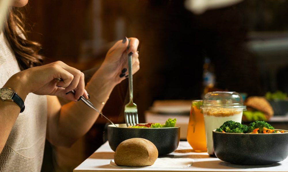 woman eating bowl of salad