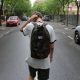 boy scratching his head while walking