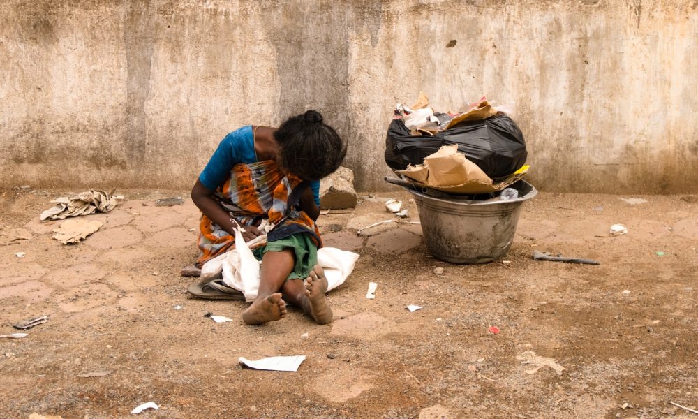 woman sitting on dirty ground