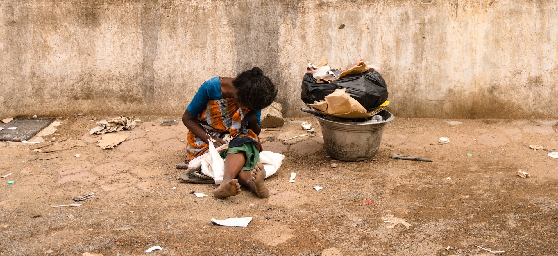 woman sitting on dirty ground