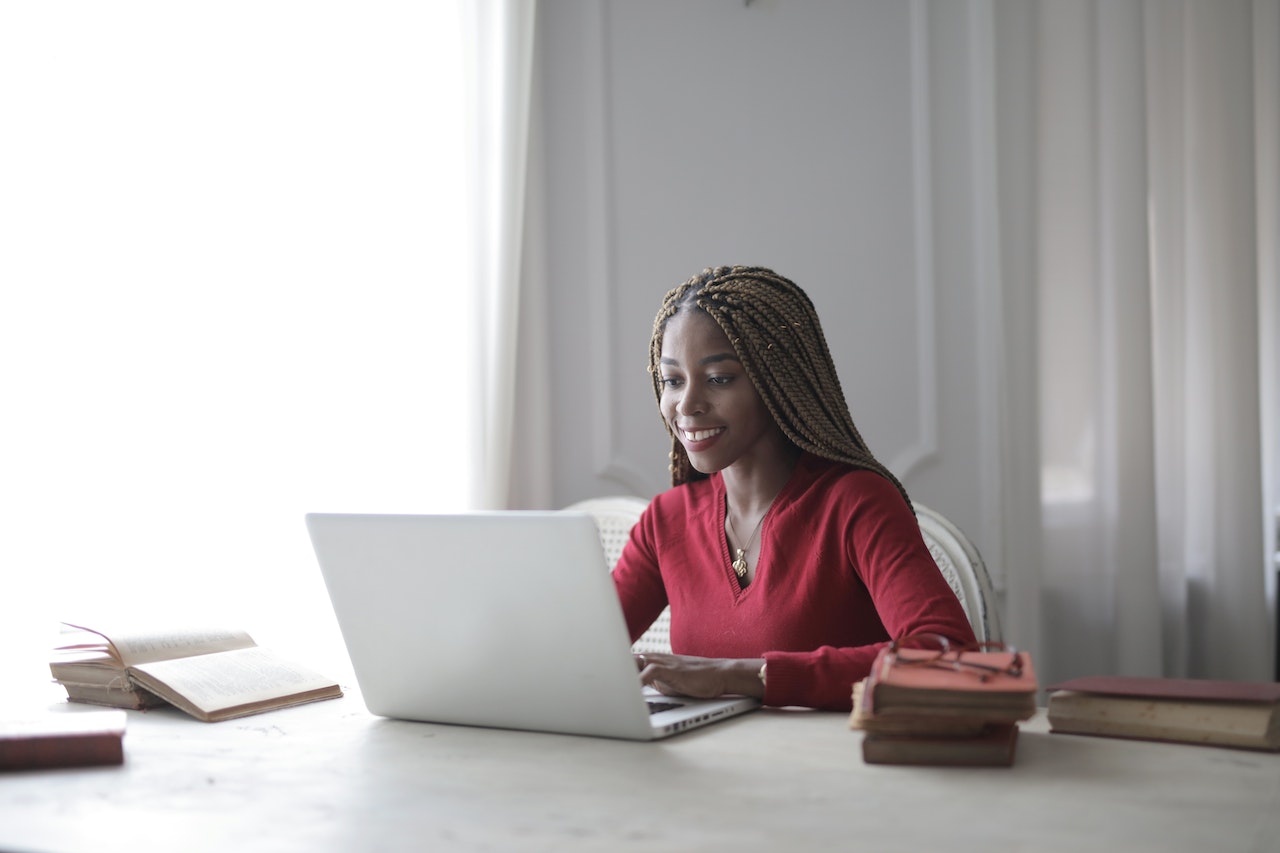 woman smiling in front of laptop