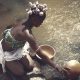 Woman Collecting Water From a Water Reservoir into Bowls