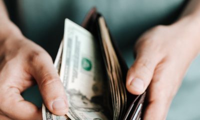 man taking out dollar bills from wallet