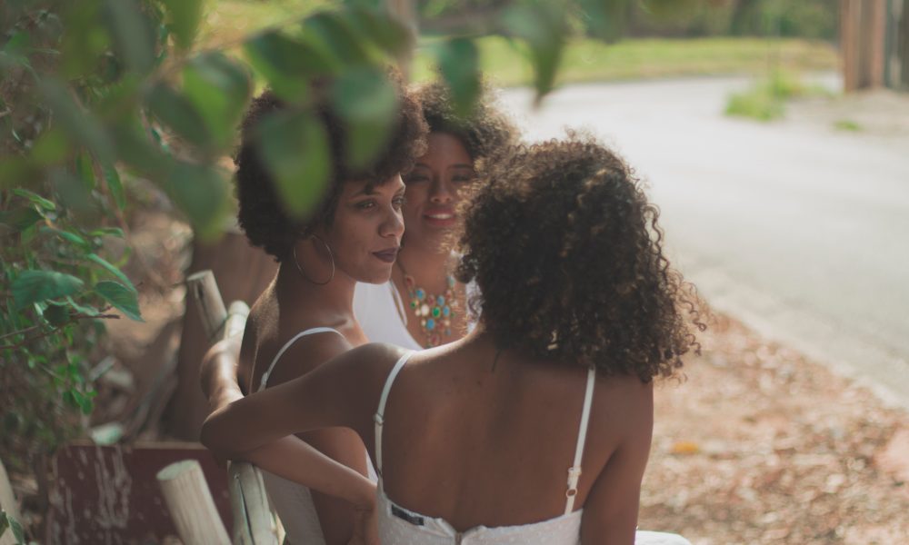 Three Women Sitting on Bench