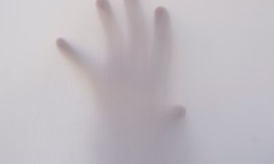 Person's Hand Touching Wall