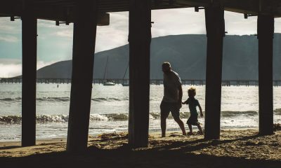 father and son walking on the shore