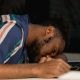 Close Up Photo of Man Sleeping on Desk