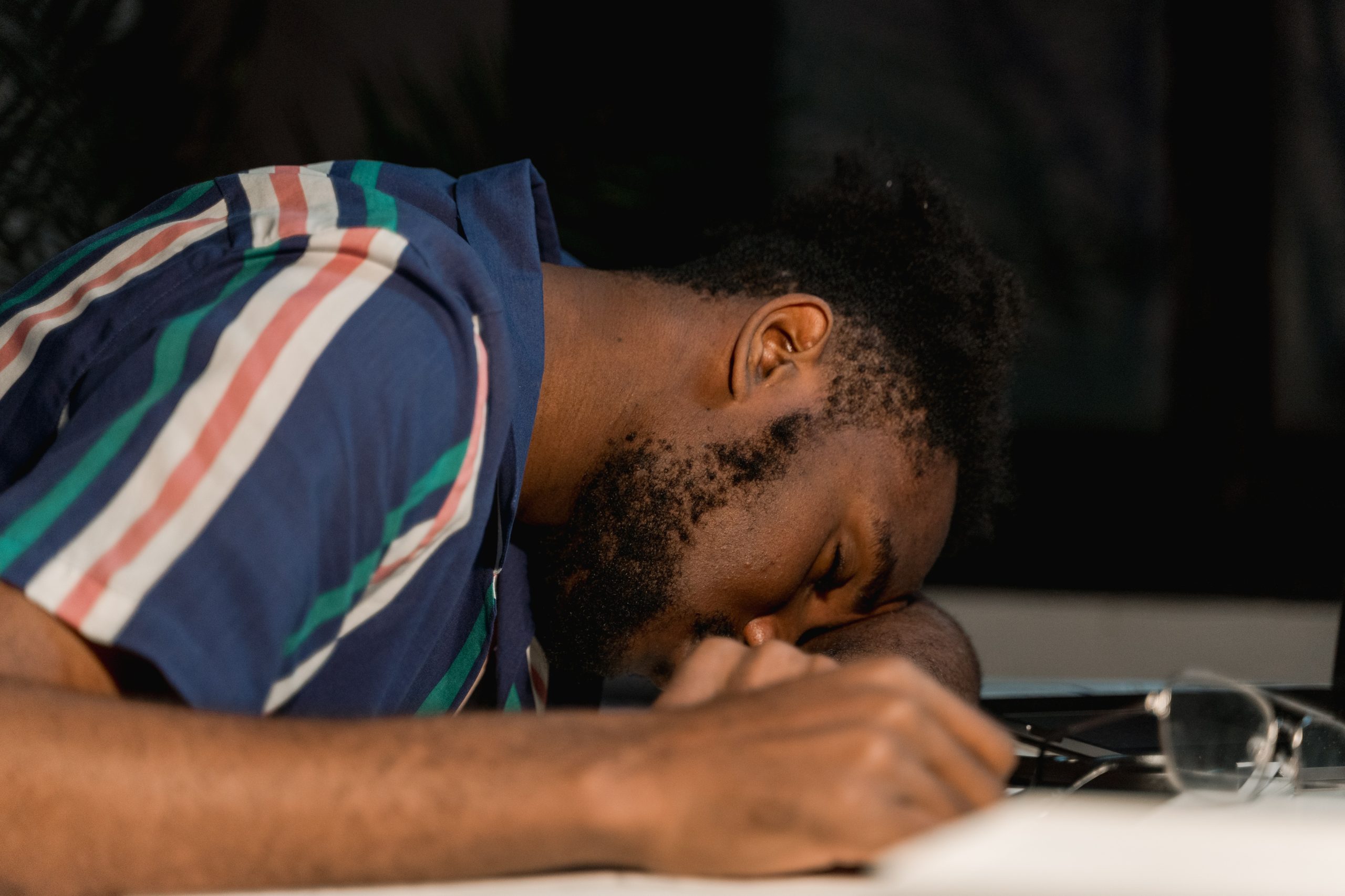 Close Up Photo of Man Sleeping on Desk