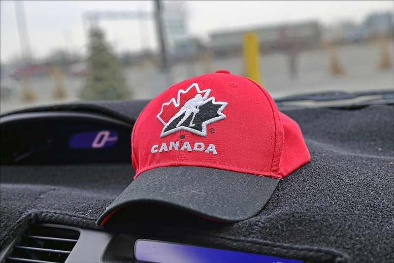 Hockey Canada cap on car dashboard