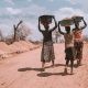 women carrying basin over their head