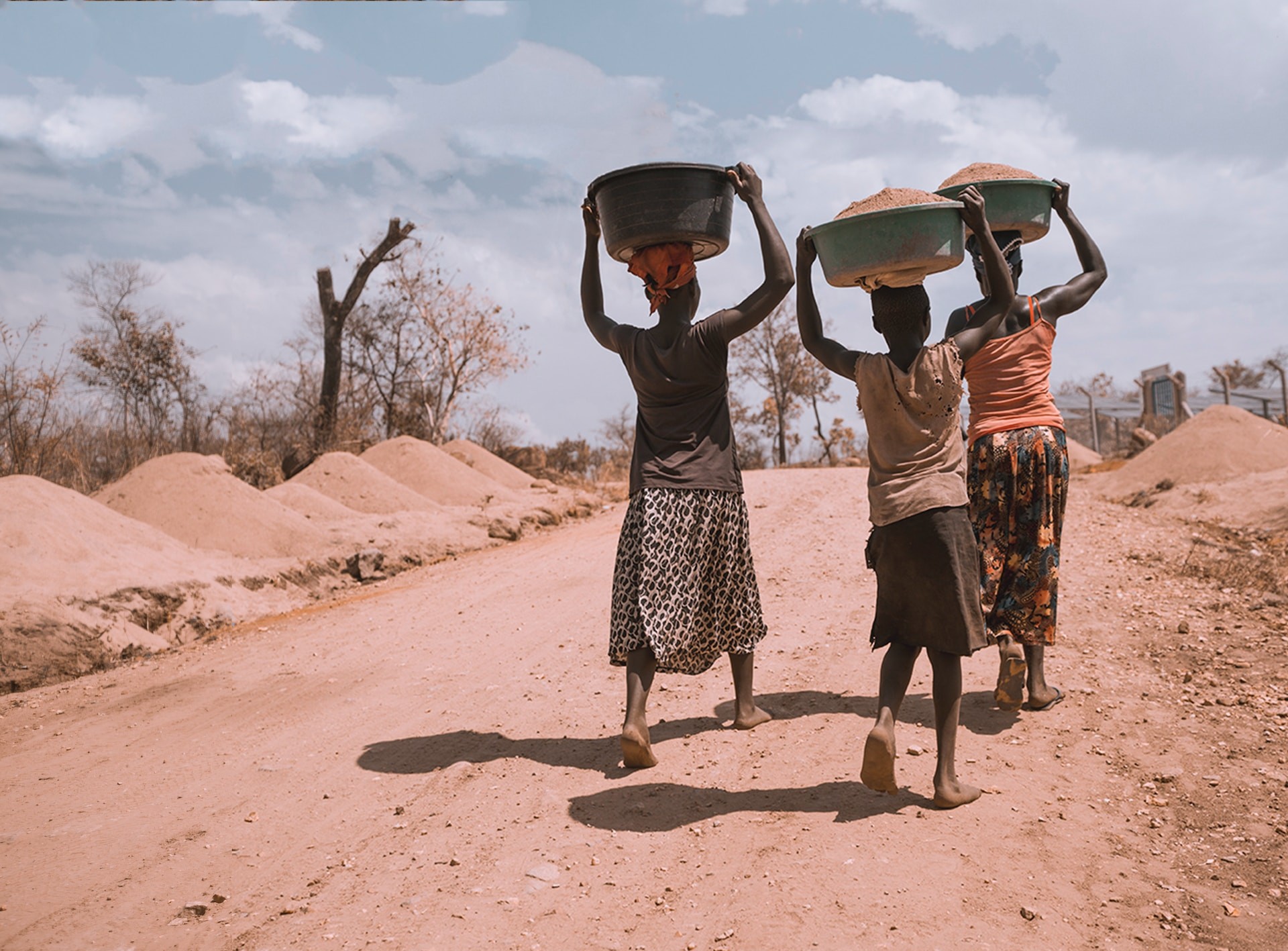 women carrying basin over their head