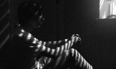 man sitting down in the dark