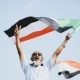 man waving sudanese flag